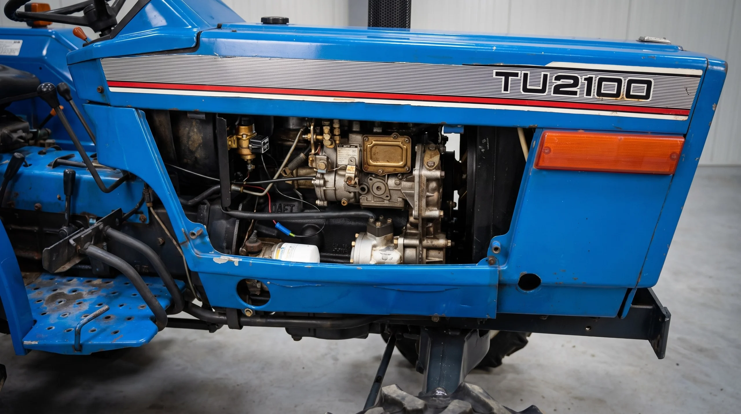 Iseki TU2100 with the side panel opened: fuel filter, oil filter and injection pump visible