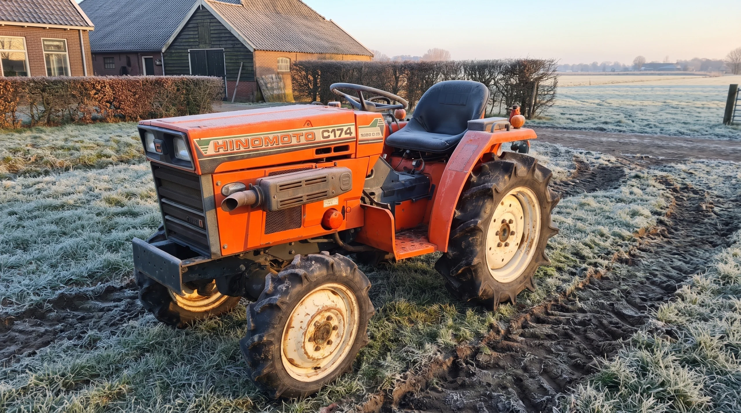 Minitractor Hinomoto C174 en un patio cubierto de escarcha en una fría mañana de invierno